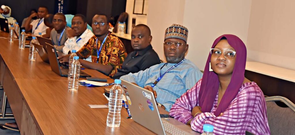 A group of people sit at a table at a training from our Niger chapter