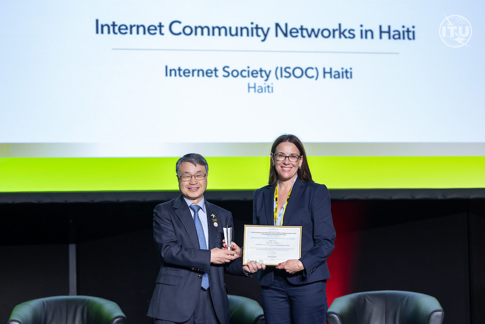 Sally Wentworth accepts an award on behalf of the Haiti Chapter